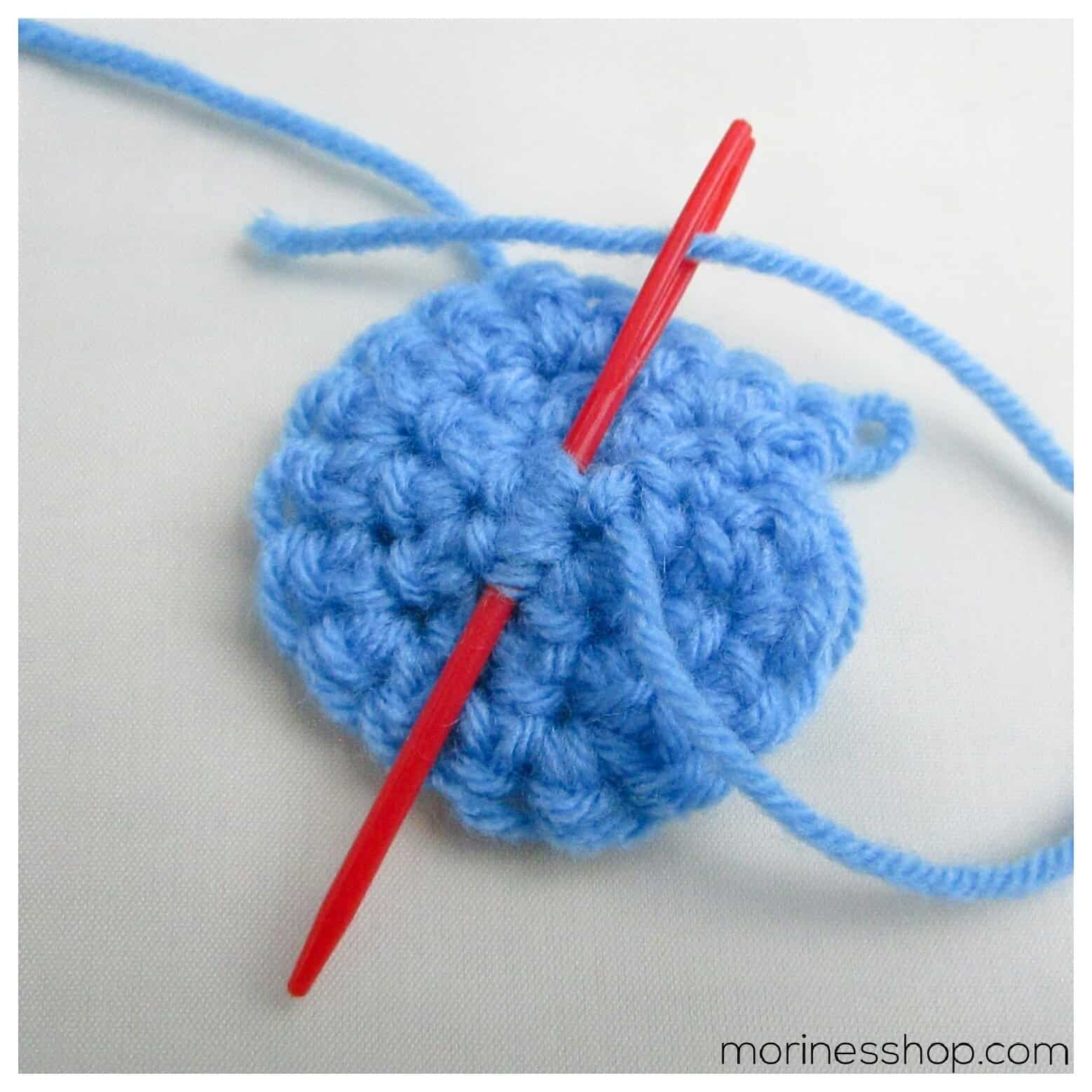 darning needle with tail end going last 3 stitches of round 1