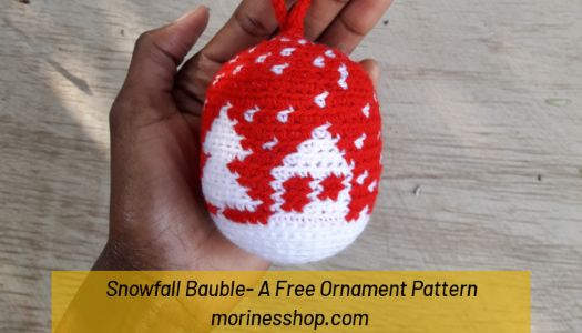 Make your own crochet ornaments this festive season with the Snowfall Bauble, a gorgeous free crochet Christmas bauble pattern #CrochetOrnaments #CrochetHoliday #HolidayDecor #CrochetDecorations #ChristmasCrochet