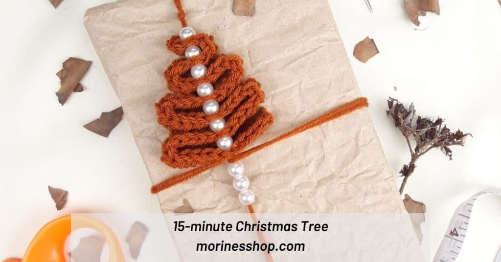 A free crochet Christmas tree pattern perfect for using as a garland, ornament or present decoration. You'll love how fast this tree works up!