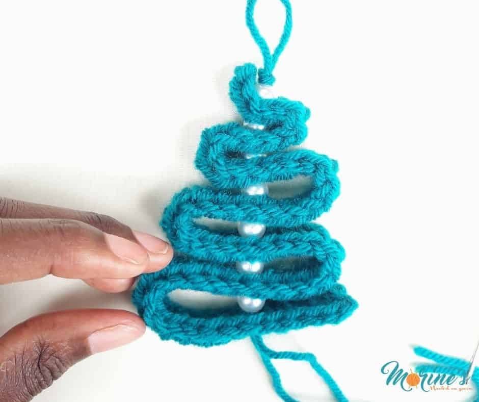 A free crochet Christmas tree pattern perfect for using as a garland, ornament or present decoration. You'll love how fast this tree works up