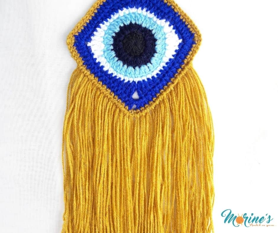 This free pattern for a Crochet Evil Eye Wall Art is simple, fun and looks lovely when added to a wall as an artful and decorative piece.