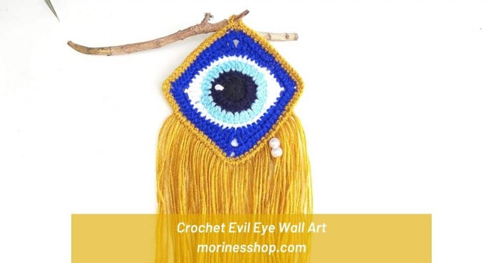 This free pattern for a Crochet Evil Eye Wall Art is made from crochet square. Accented with gold yarn and pearl beads for a tear drop effect.